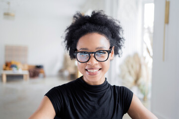 Wall Mural - A woman with glasses looks at the camera