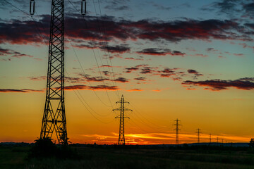 Wall Mural - Detail of electric pole with electric cables at sunset