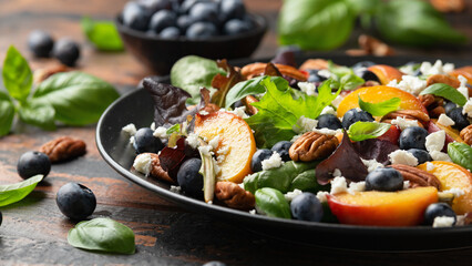 Wall Mural - Peach, blueberry salad with vegetables, feta cheese and pecan nuts. Healthy summer food