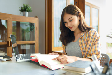 Wall Mural - Education and literacy concept, College student girl is reading a book in college library