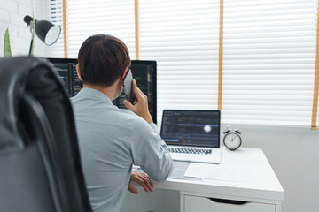 Wall Mural - software development concept, male programmer talking on smartphone and check data code on monitor