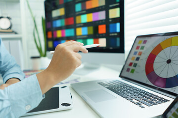 Wall Mural - creativity concept, male graphic designer pointing color swatch samples and drawing on tablet