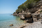 Fototapeta Morze - Rocky shore of mediterranean sea bay closeup in sunny summer day