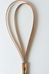 Wall Mural - two vintage cedar wood straps bent in an elegant hoop and held in place with a clothespin clip