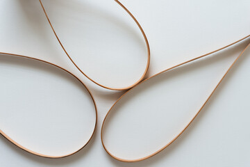 Wall Mural - three curved vintage cedar wood straps on a light background