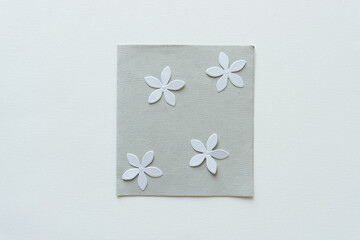 Canvas Print - four paper flower shaped confetti on a paper tile