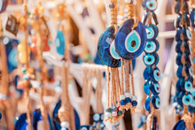 Evil Eye Turkish Bead Amulets Hanging In Souvenir Store. Gift And Superstitions Concept