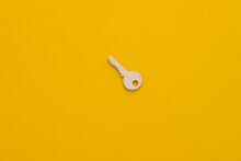 Life Coaching Concept - Wooden Key Standing On A Yellow Background