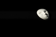 White Gypsum Mask Of Human With Closed Eyes On Black Background