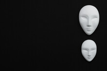 Two White Gypsum Mask Of Human With Closed Eyes On Black Background