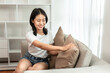 © Katcha - Half-Japanese woman cleaning the sofa and cushions in the living room, Cleans deep stains in upholstery and seats., Weekend routine, big cleaning. Eliminate germs in the room