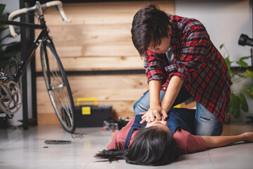 Wall Mural - First aids emergency CPR on heart attack woman laying unconscious in home, One part of the process resuscitation - healthcare and insurance concept.