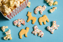 Cute Circus Animal Crackers On A Blue Background With Popcorn In