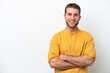 © luismolinero - Young caucasian man isolated on white background keeping the arms crossed in frontal position