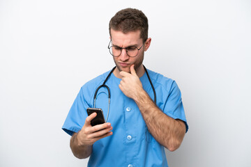 Poster - Young surgeon doctor caucasian man isolated on white background thinking and sending a message