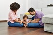 © Krakenimages.com - Couple and daughter smiling confident playing with toys sitting on the floor at home