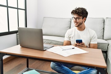 Sticker - Young hispanic man smiling confident working at home