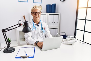 Canvas Print - Young caucasian man wearing doctor uniform working at clinic