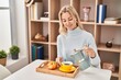© Krakenimages.com - Young blonde woman having breakfast sitting on table at home