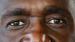 © Yuliia - Extreme close up body part human male wrinkled face african american senior elderly adult man with dark iris eyesight masculine person looking at camera with healthy expression ophthalmology service