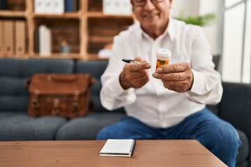 Sticker - Senior man psychologist smiling confident prescribe pills at psychology center