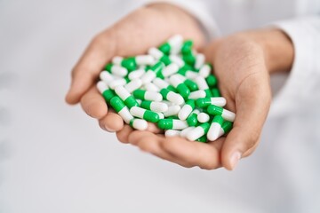 Poster - Young arab man pharmacist holding capsules at pharmacy