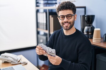 Canvas Print - Young arab man business worker counting dollars at office