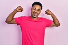 Young African American Man Wearing Casua T Shirt Celebrating Surprised And Amazed For Success With Arms Raised And Open Eyes. Winner Concept.