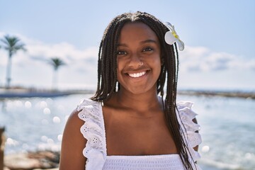 Sticker - Young african american girl smiling happy standing at the beach.