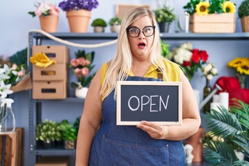 Sticker - Caucasian plus size woman working at florist holding open sign scared and amazed with open mouth for surprise, disbelief face