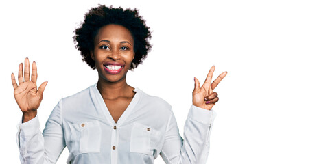 Canvas Print - African american woman with afro hair wearing casual white t shirt showing and pointing up with fingers number eight while smiling confident and happy.