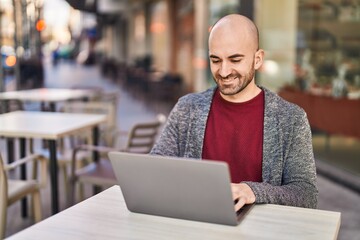 Sticker - Young man using laptop sitting on table at coffee shop terrace