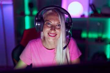 Sticker - Young blonde woman streamer smiling confident using computer at gaming room