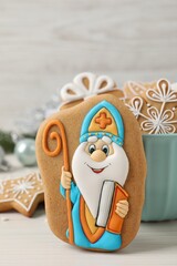 Wall Mural - Tasty gingerbread cookies on white wooden table. St. Nicholas Day celebration