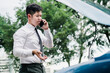 © Kiattisak - Asian businessman broken car engine breakdown his use mobile calling insurance smartphone problem, Accident emergency on the road concept.