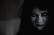 © sorapop - Asian woman ghost or zombie horror creepy scary close up she face and hair covering the face her eye looking to camera at night, Halloween day concept, in dark tone