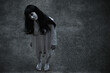 © sorapop - Woman ghost horror standing under building house her looking up, halloween concept