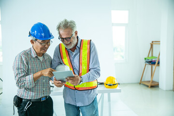 Expertise engineers are planning about the project by using tablet devices. Engineering workplace on white background with effect filter. Workers are working plan on agriculture project concept.