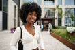 © fotofabrika - Portrait of young african woman with afro hairstyle smiling in urban background