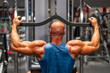 © Westend61 - Muscular bodybuilder using lat pulldown machine in gym