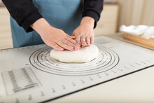 The Cook's Hands Are Ready To Knead The Wheat Dough On A Silicone Baking Mat With Different Markings For Ease Of Use.