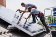 © Westend61 - Craftsmen installing solar panels on house rooftop