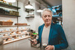 © Westend61 - Senior businessman with coffee cup and mobile phone in cafe