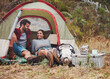 © Jacob Lund - Loving young couple sitting in a camping tent