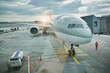 © Westend61 - Germany, Hesse, Frankfurt, Commercial airplane waiting on airport tarmac