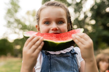 Cute Girl Eating Watermelon Standing At Park