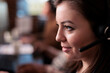 © DC Studio - Telecommunication receptionist answering client call on headset, talking to people on remote helpline support. Young telework operator using customer care service equipment. Close up.