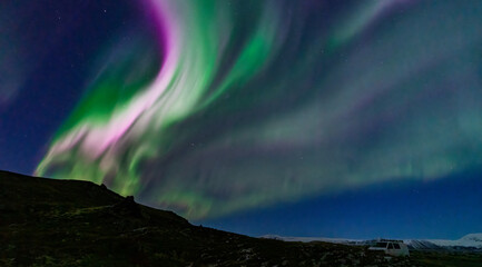 northern lights with green and purple colors over the parking
