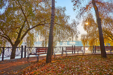 Sticker - The benches in shady autumn park on Dnieper River, Kyiv, Ukraine