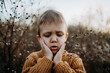 © Halfpoint - Portrait of sad, worried little boy wearing knitted sweater in nautre, autumn concept.